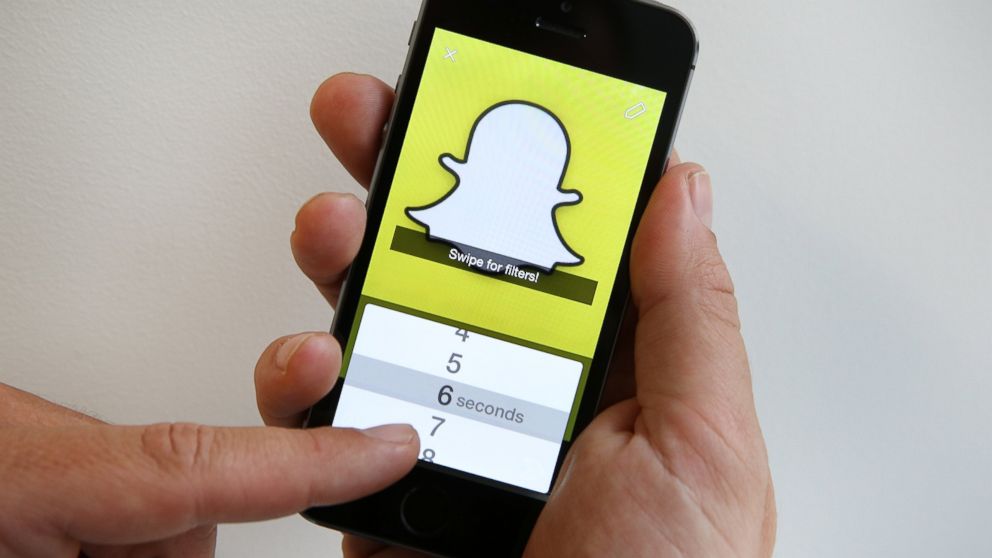 The Snapchat app is demonstrated for this photo illustration in London, England on Oct. 6, 2014.