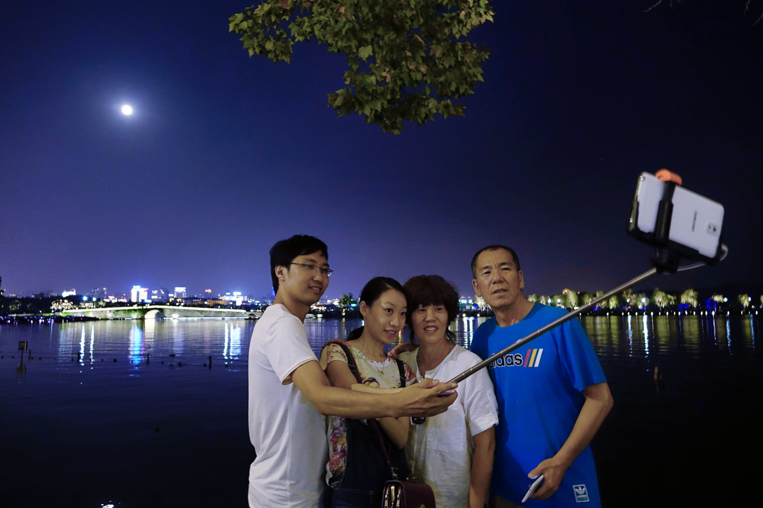 PHOTO: People take selfies with the full moon at the West Lake during the Mid-Autumn Festival, on Sept. 27, 2015 in Zaozhuang, China.