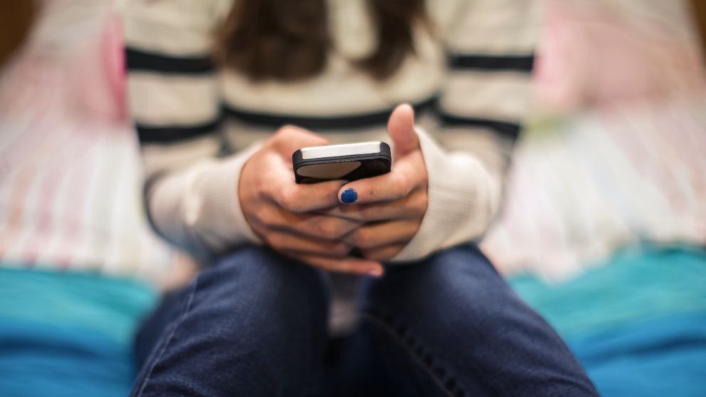 A teenage girl uses a smartphone in this undated stock image.