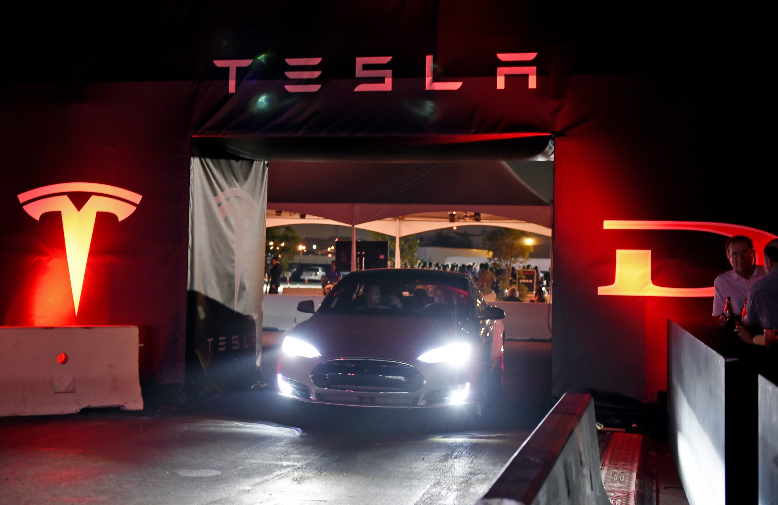 PHOTO: Tesla owners take a ride in the new Tesla "D" model electric sedan at the Hawthorne Airport on Oct. 09, 2014 in Hawthorne, Calif.