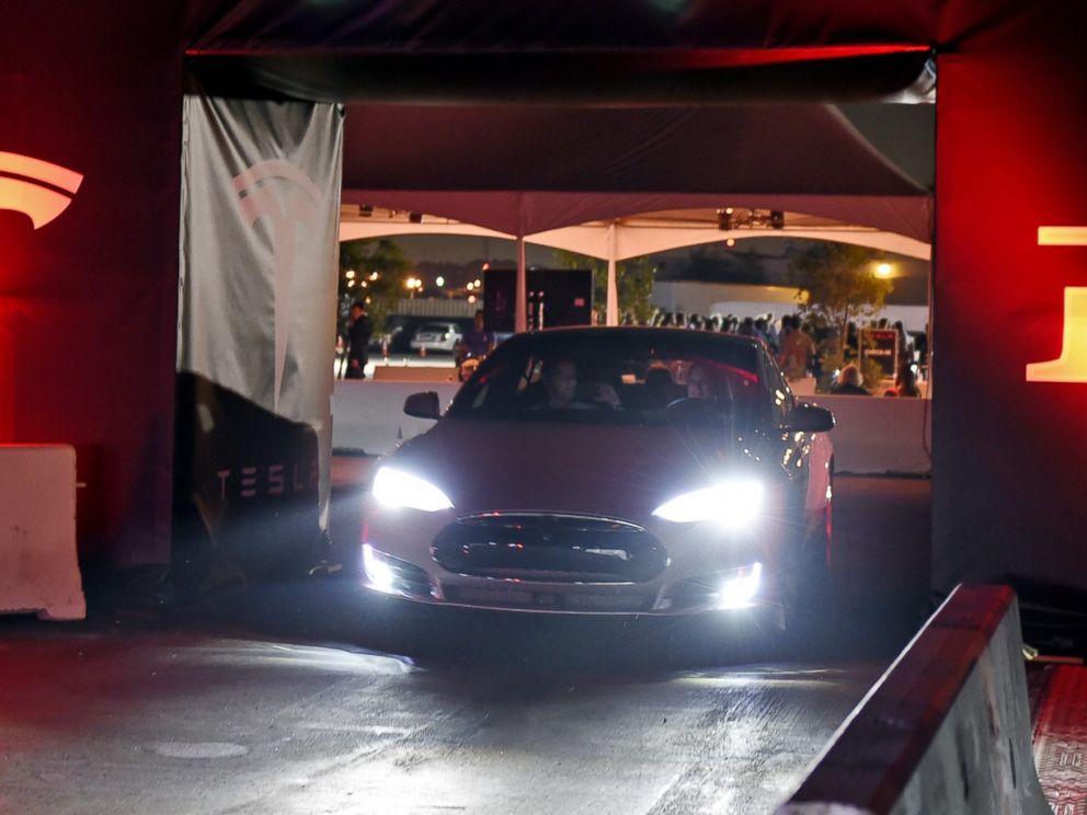 PHOTO: Tesla owners take a ride in the new Tesla D model electric sedan at the Hawthorne Airport on Oct. 09, 2014 in Hawthorne, Calif.