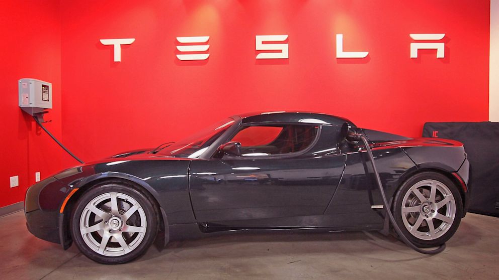 A Tesla Roadster Sport sits in a dealership showroom, Nov. 3, 2011, in Chicago.