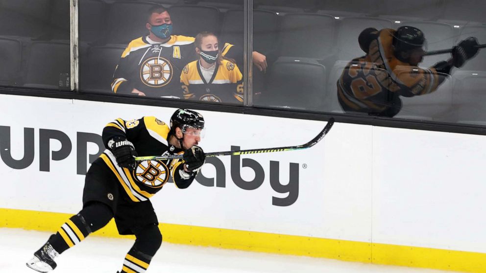 PHOTO: Fans watch game action with Brad Marchand during the Bruins vs. New York Islanders match in Boston, May 10, 2021.