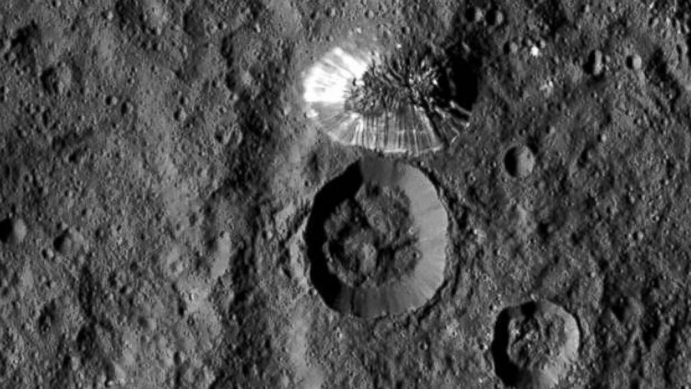 NASA's Dawn spacecraft spotted this tall, conical mountain on Ceres from a distance of 915 miles (1,470 kilometers). The mountain, located in the southern hemisphere, stands 4 miles (6 kilometers) high. Its perimeter is sharply defined, with almost no accumulated debris at the base of the brightly streaked slope.
