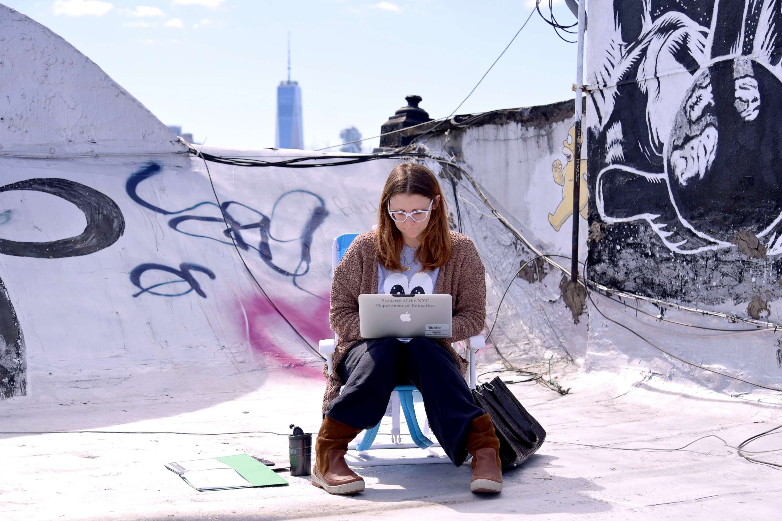 PHOTO: A school teacher teaches on her laptop from her roof in New York, March 24, 2020.