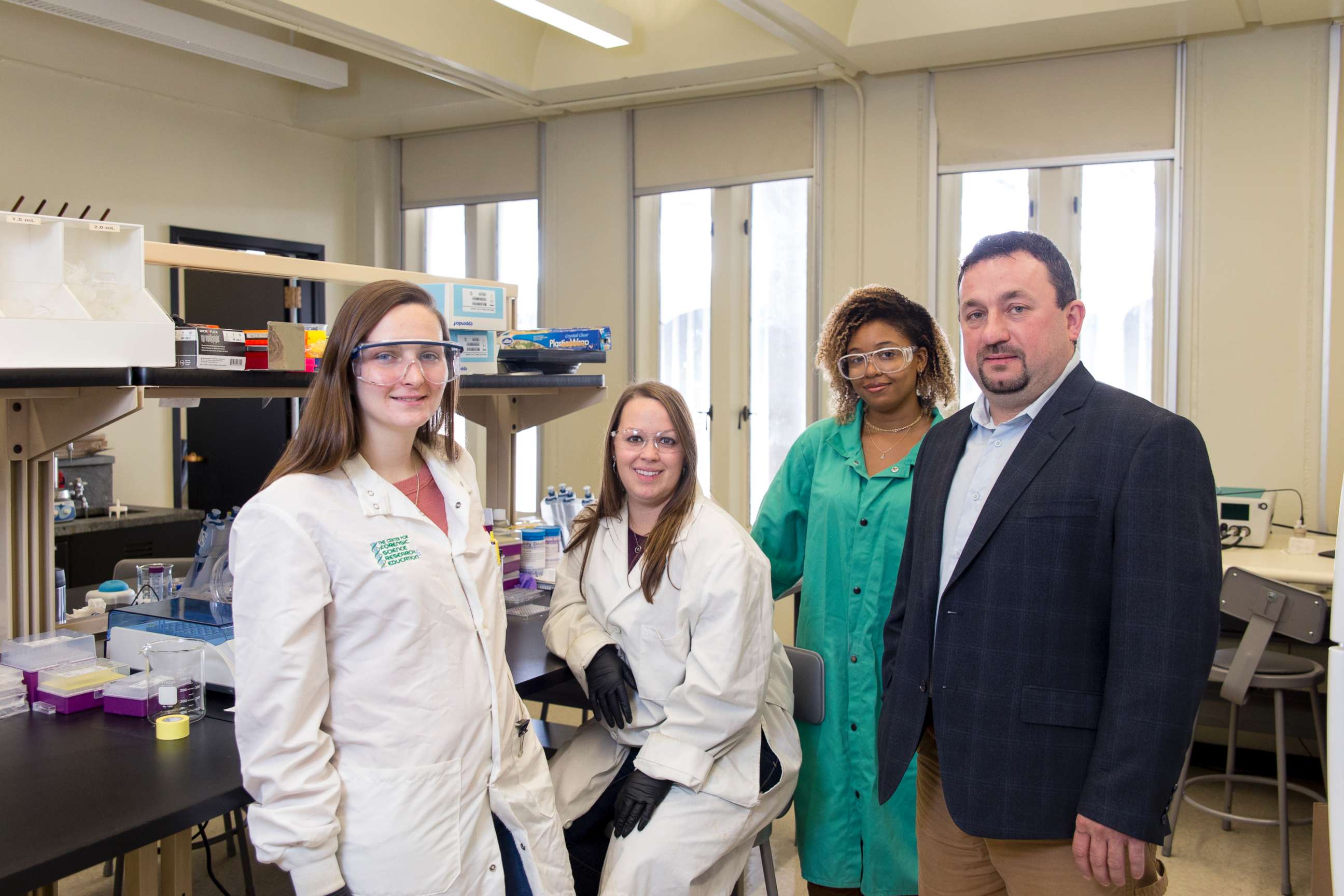 PHOTO: Assistant Professor Jan Halamek, Ph.D, working with Erica Brunelle, 4th year Chemistry PhD candidate; Mindy Hair, 2nd year Chemistry PhD candidate; and Adrianna Mathis '18 Chemistry, Nov. 2, 2017. 