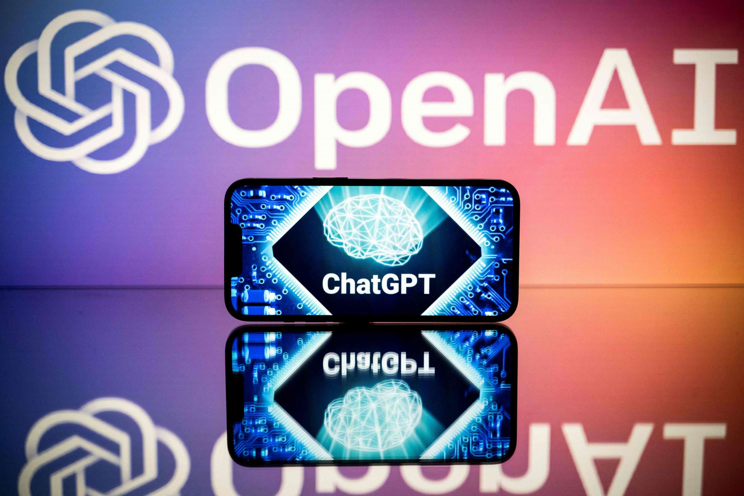PHOTO: This file photo taken on January 23, 2023 in Toulouse, France, shows screens displaying the logos of OpenAI and ChatGPT.