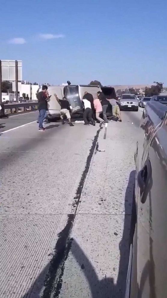 PHOTO: In a screen grab from a video posted to Jorge Tiznado's twitter account, Jorge's father and other people help rescue a driver from a flipped over pickup truck.