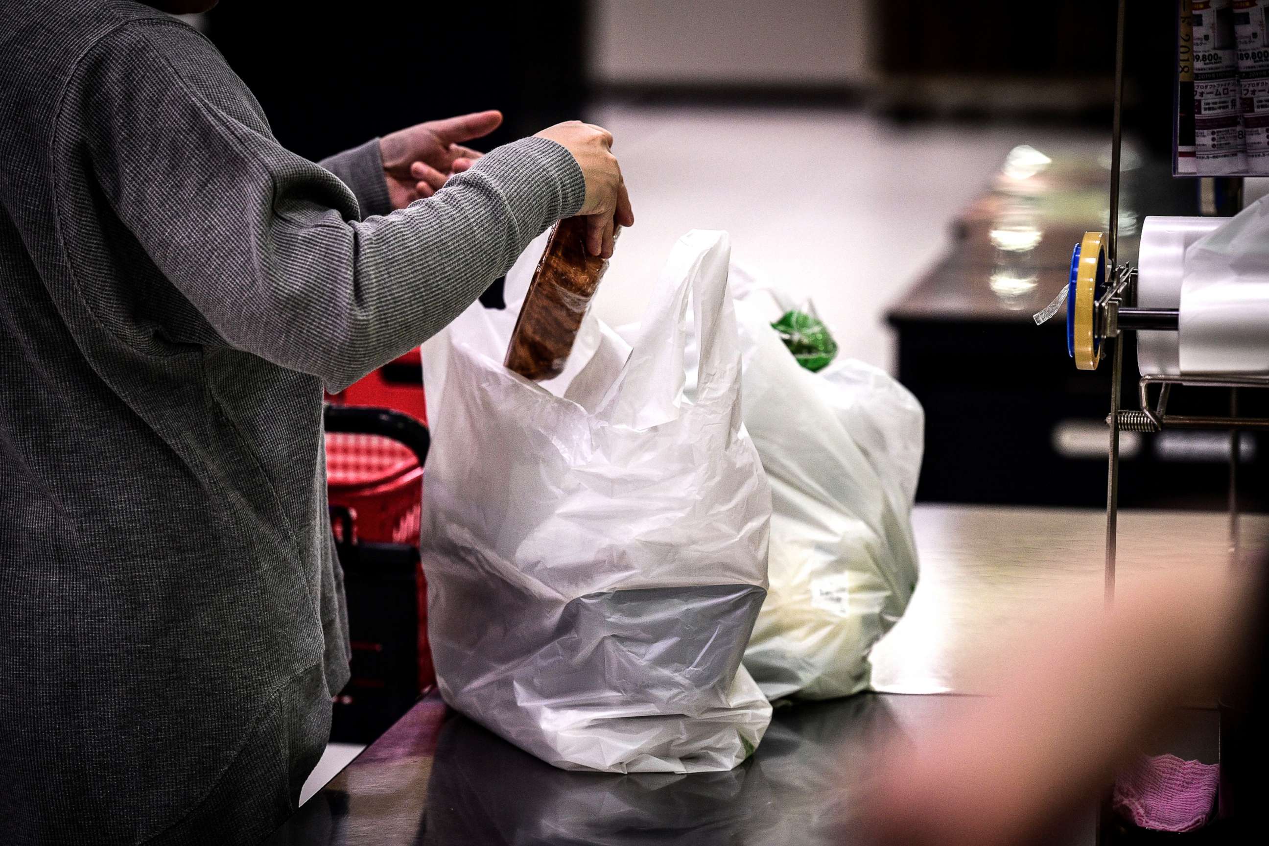 PHOTO: In this picture taken on Nov. 7, 2018, a woman packs her shopping into a plastic bag in a supermarket in Chiba, Japan.