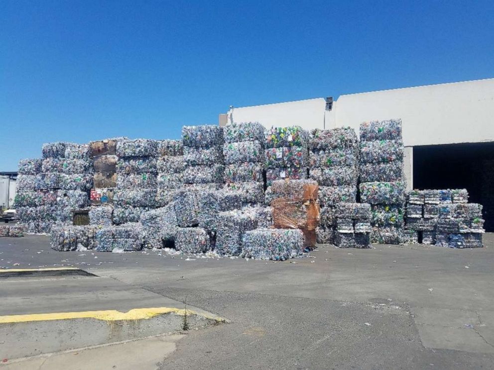 PHOTO: Stacks of plastic bottles are seen outside Ming's Recycling.