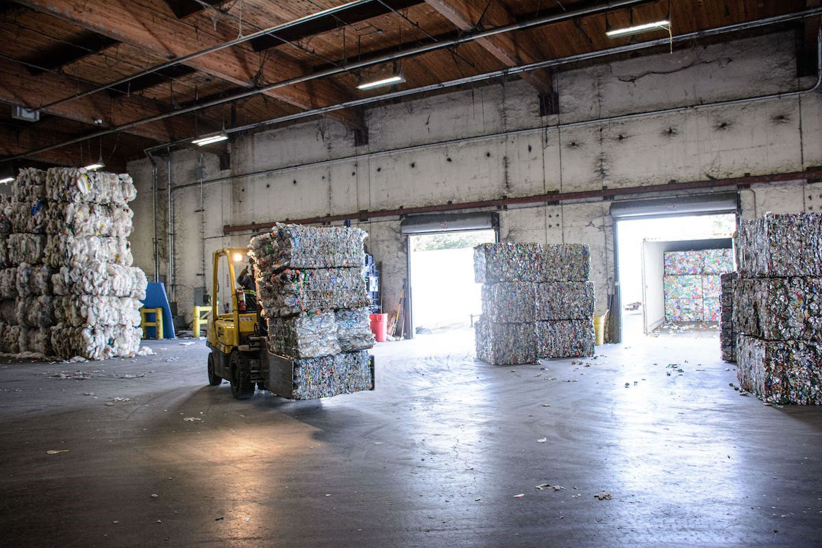 PHOTO: A forklift carries a bale of plastic bottles at Ming's Recycling.