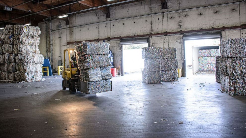 Photo: A forklift carries a stack of plastic bottles at Ming's Recycling.