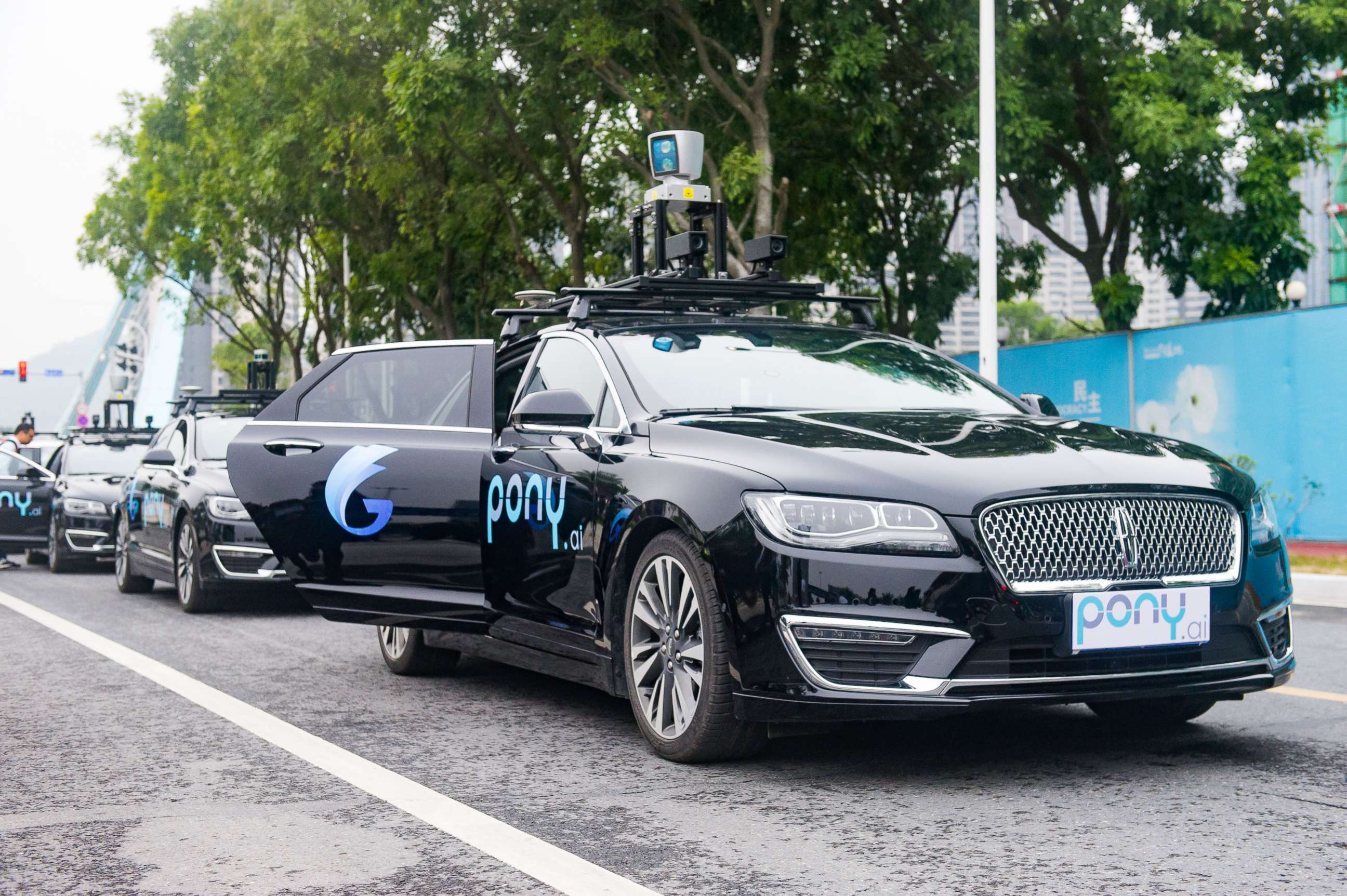 PHOTO: Pony.ai self-driving cars run along a road during a trial run, Feb. 2, 2018, in Guangzhou, China.