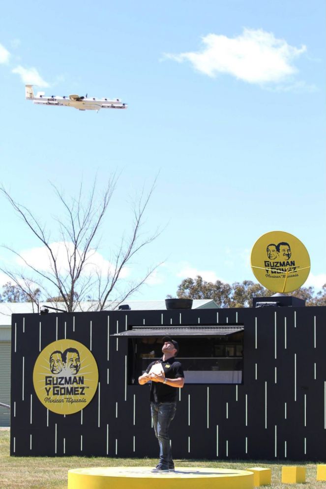 PHOTO: A photo posted to the company's blog shows CEO of Australia's Guzman y Gomez restaurant chain waiting for a Project Wing drone to drop a hook in order to attach food during a burrito delivery test in Queanbeyan, Australia.