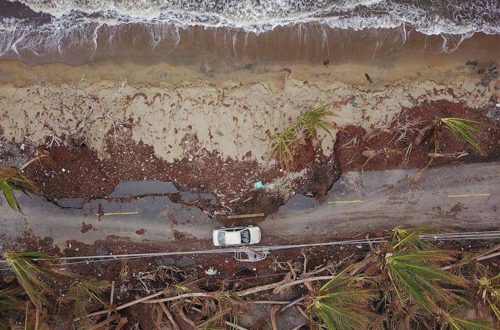 PHOTO: A car drives on a damaged road in the aftermath of Hurricane Maria in Humacao, Puerto Rico on Oct. 2, 2017.