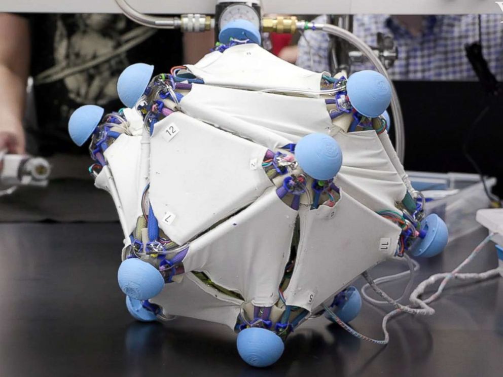PHOTO: Multiple triangular robotic skins attached to tensegrity vertices to form a rolling locomotion of the robot.