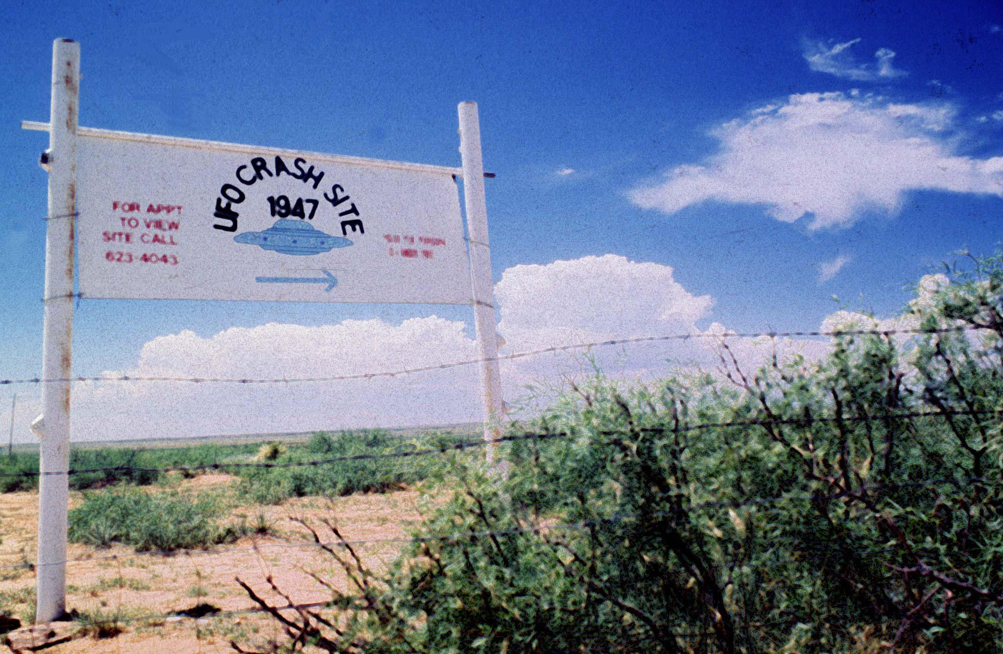 PHOTO: A sign off route U.S. 285, north of Roswell, New Mexico, points west to the alleged 1947 crash site of a flying saucer on the Corn Ranch, June 20 1997.