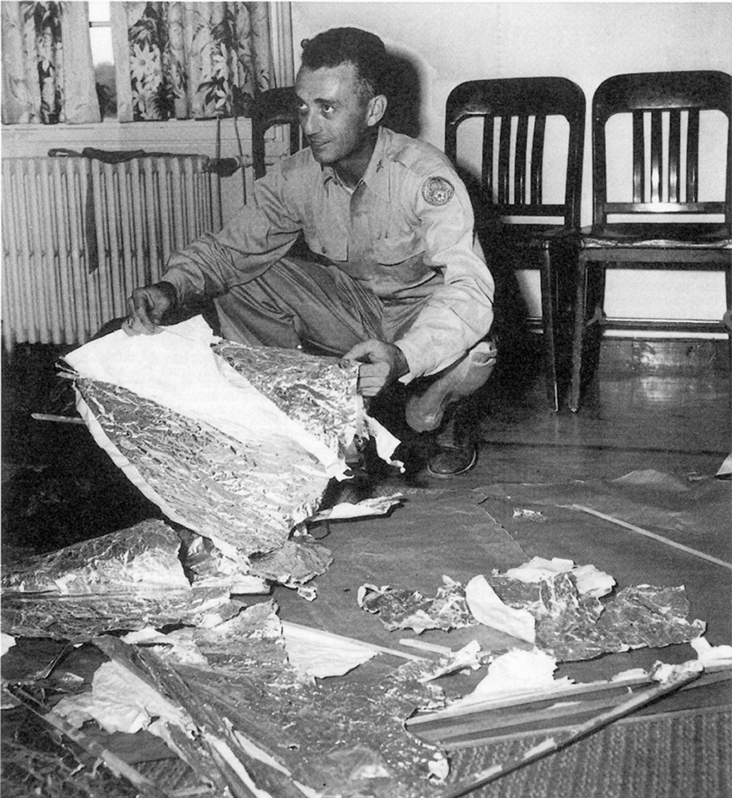 PHOTO: Major Jesse Marcel from the Roswell Army Air Field with debris found 75 miles north west of Roswell, N.M., in June 1947.