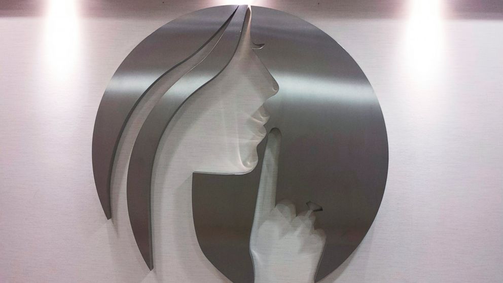 PHOTO: An AshleyMadison.com logo featuring the image of a woman motioning to whisper, is seen at the entry to Avid Life Media's offices in Toronto, July 20, 2015.