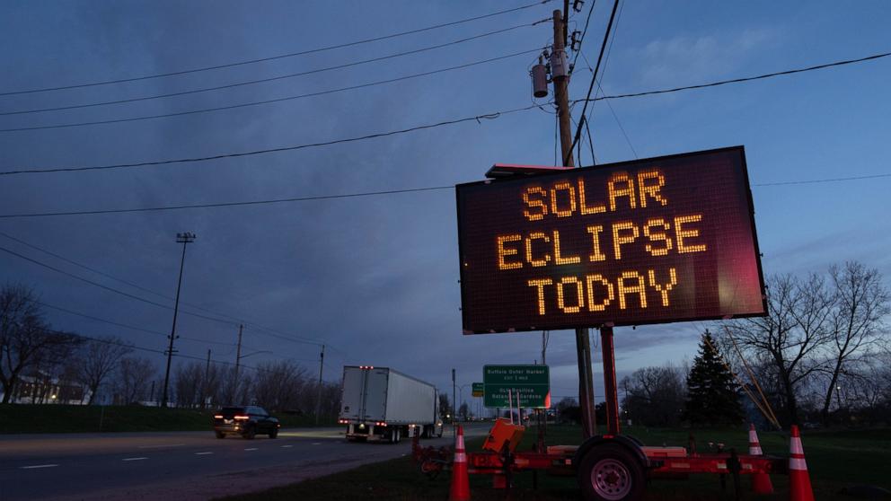 PHOTO: A matrix road sign displays a message for drivers about the solar eclipse on April 8, 2024 in Lackawanna, New York.