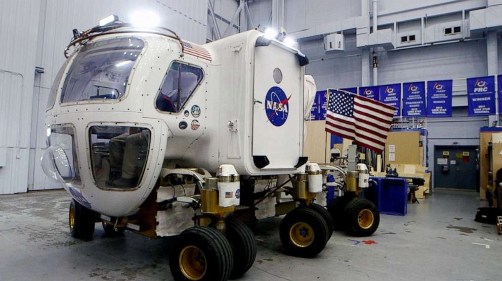 PHOTO: Lucien Junkin, NASA Johnson Space Center's chief engineer for the Space Exploration Vehicle, demonstrates how to maneuver the planetary rover.