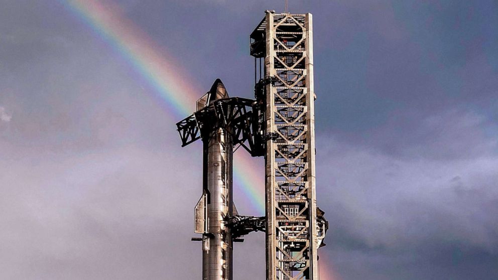 PHOTO: FILE - This handout image provided by SpaceX shows a rainbow in the sky behind the 164-foot (50-meter) tall Starship spacecraft sitting atop the 230-foot tall Super Heavy rocket from Starbase in Boca Chica, Texas, April 10, 2023.