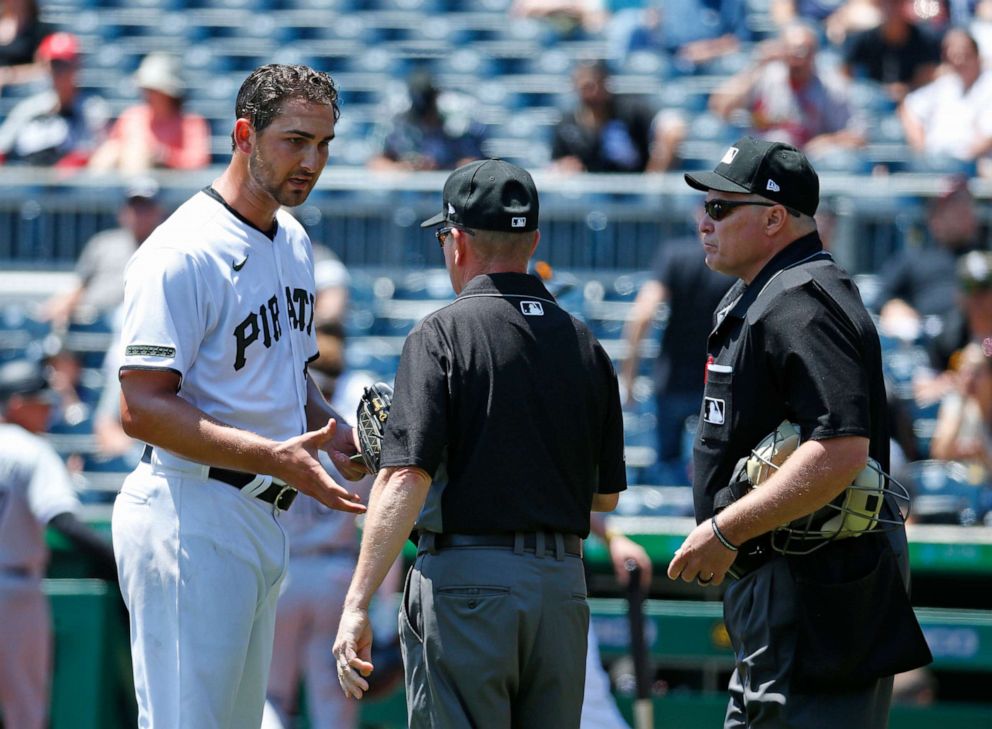 PHOTO: Chase De Jong of the Pittsburgh Pirates is checked for sticky substances by umpires Jerry Meals and Marvin Hudson against the Chicago White Sox during inter-league play at PNC Park on June 23, 2021 in Pittsburgh, Pa.