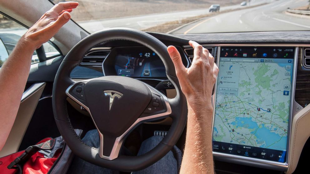 In this file photo dated Oct. 14, 2015, a member of the media test drives a Tesla Motors Inc. Model S car equipped with Autopilot in Palo Alto, Calif.