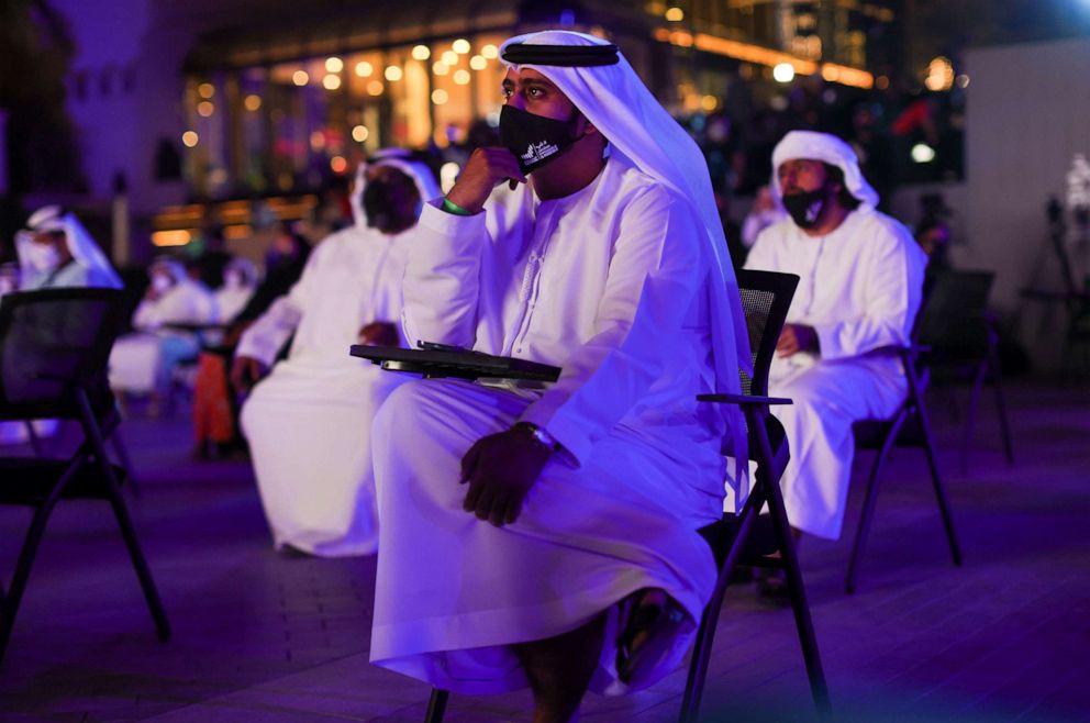 PHOTO: People watch a screen displaying information of the Hope Probe entering the orbit of Mars, in Dubai, United Arab Emirates, Feb. 9, 2021.