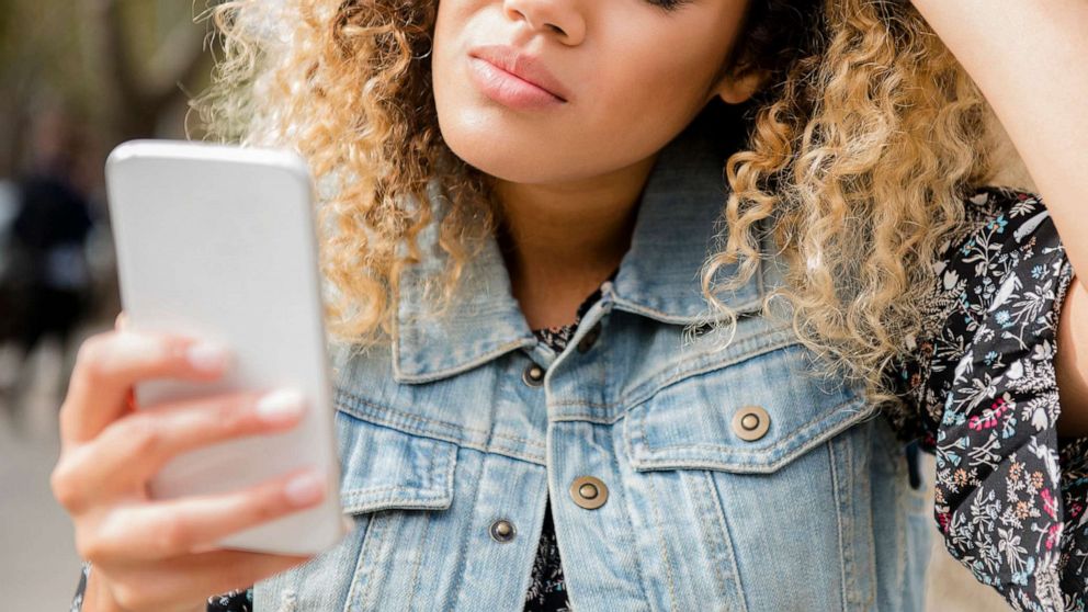 PHOTO: An undated stock photo depicts an unhappy woman looking at her smartphone.