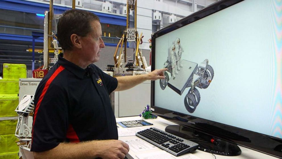 PHOTO:Lucien Junkin shows a design of a new unpressurized rover he's working on. The rover is slated to help astronauts in their return to the moon in 2024.