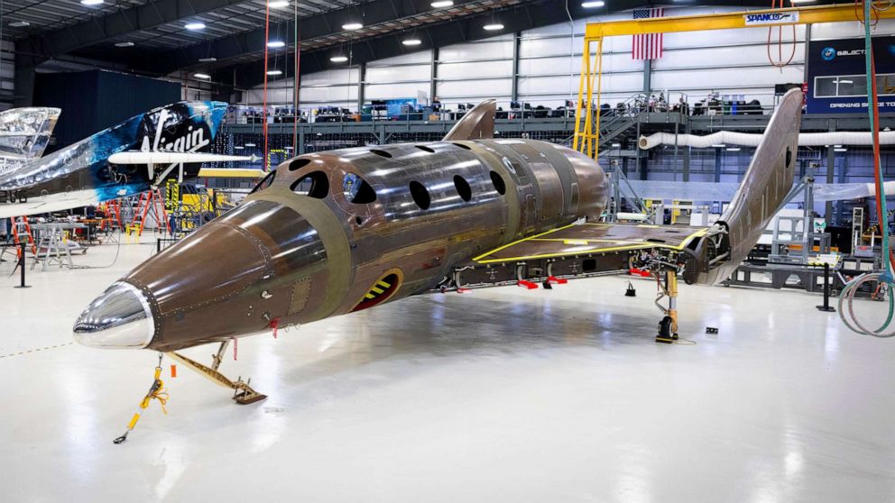 PHOTO: This photo released by Virgin Galactic Wednesday, Jan. 8, 2020, shows Virgin Galactic's next passenger spaceship standing on its landing gear in a hangar at the company's Mojave Air & Space Port in Mojave, Calif.