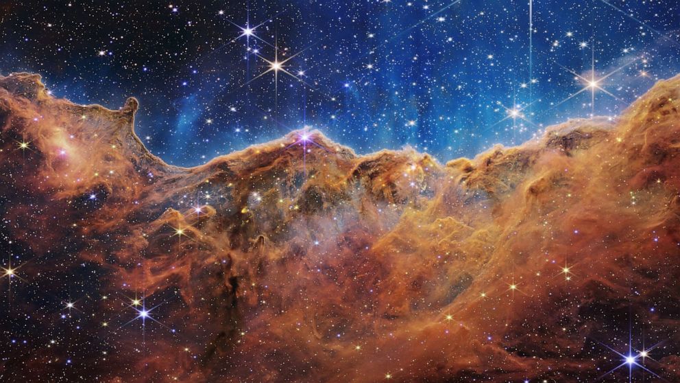 PHOTO: Behind the curtain of dust and gas in these Cosmic Cliffs are previously hidden baby stars, discovered by NASA's James Webb Space Telescope in an image released July 12, 2022.