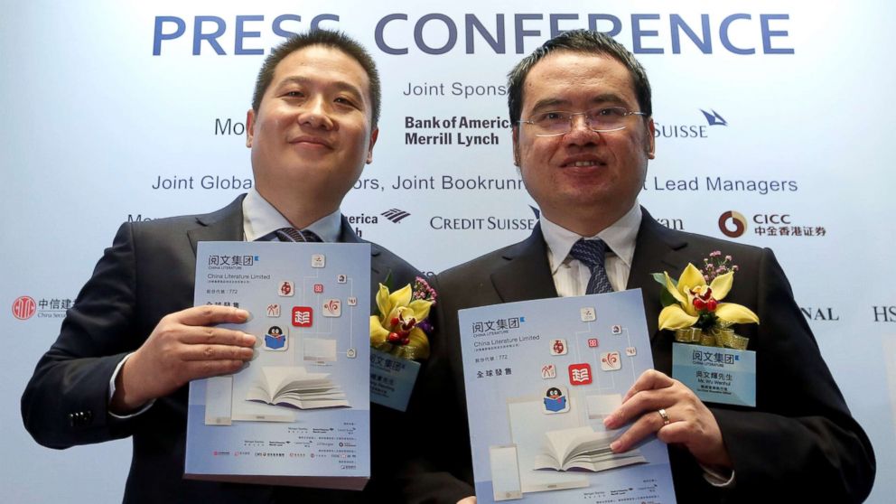 PHOTO: China Literature Co-Chief Executive Officers Liang Xiaodong (L) and Wu Wenhui pose during a news conference on the company's IPO in Hong Kong, China, Oct. 25, 2017. 
