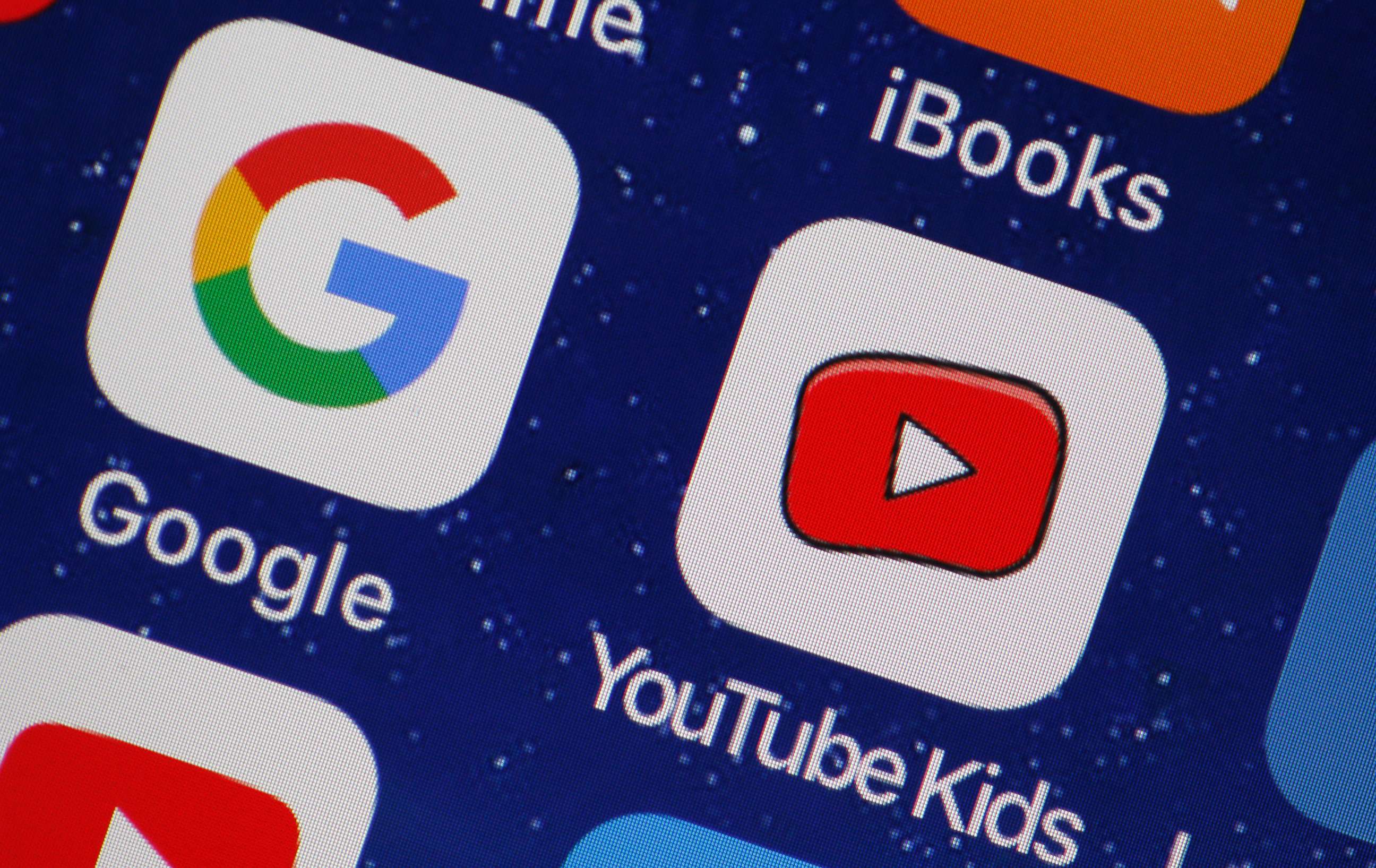 PHOTO: In this photo illustration, the logo of the Google and You Tube Kids applications are displayed on the screen of an Apple iPhone, April 10, 2018, in Paris.