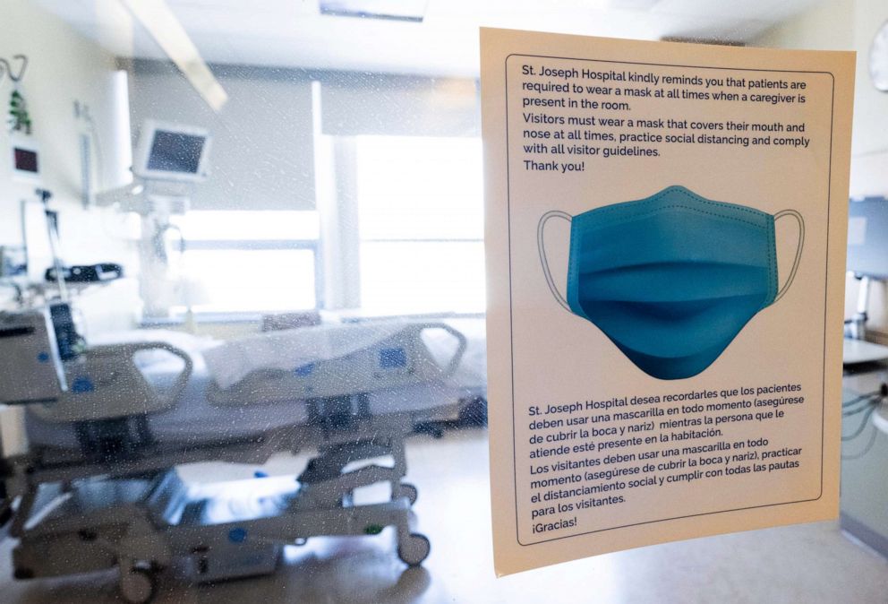PHOTO: A sign reminds visitors and staff of social distancing and mask requirements at Providence St. Joseph Hospital in Orange, Calif., April 14, 2022. 