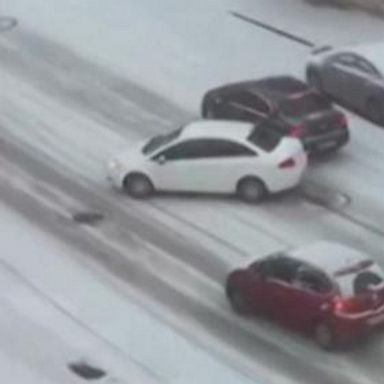 VIDEO: Cars slide out of control down icy road