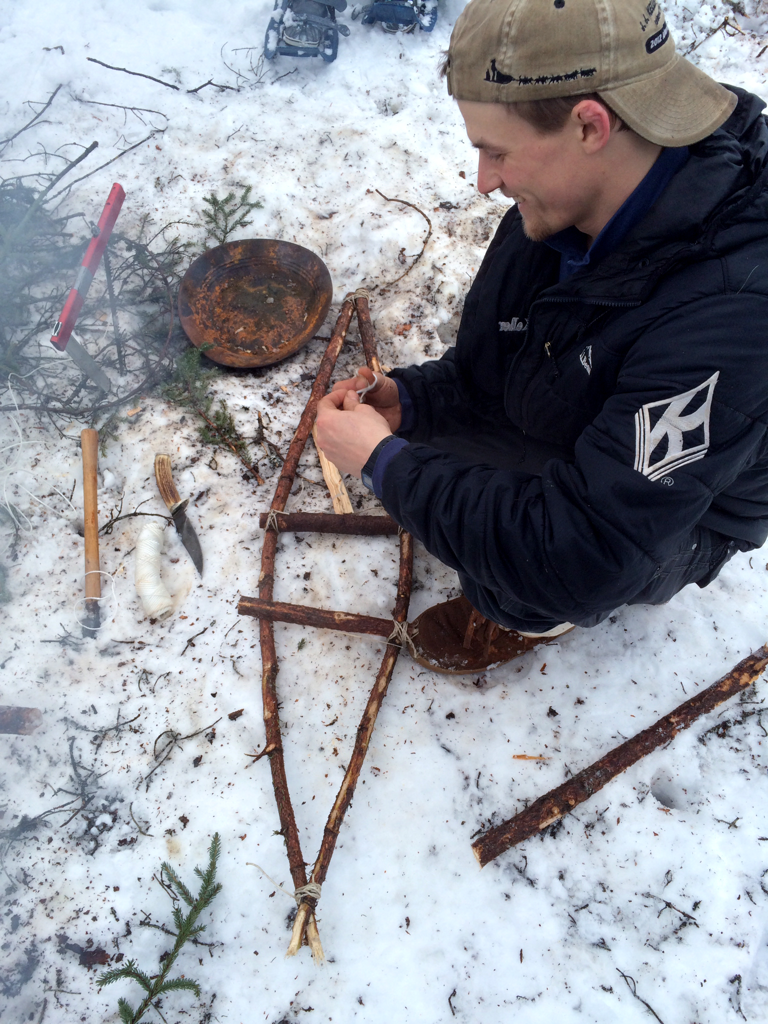 PHOTO: Dallas Seavey shows how to make snowshoes out of tree branches.