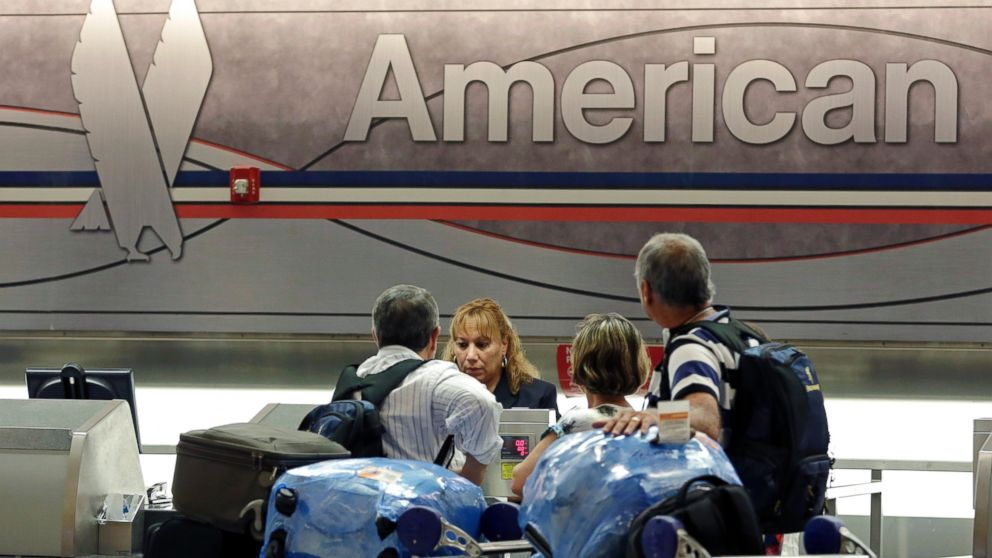 Passengers check in at the American Airlines counter at Miami International Airport in Miami, May 27, 2014.