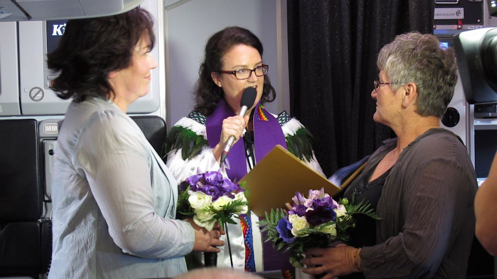 Lynley Bendall, left, and Ally Wanikau, right, got married by celebrant Kim Jewel Elliott, Aug. 19, 2013, on a flight that left from Queenstown, New Zealand.