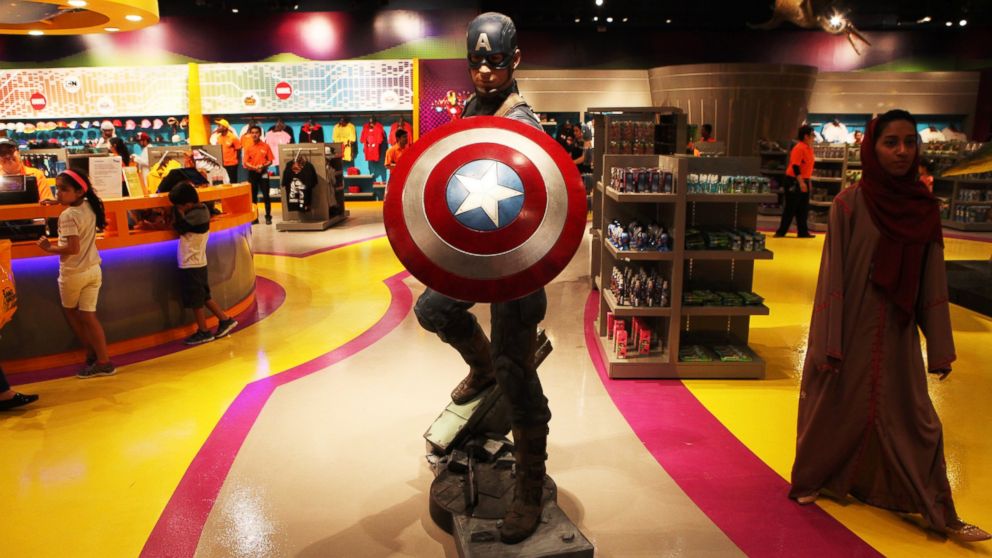 An Emirati woman walks past a statue of Captain America at the IMG Worlds of Adventure amusement park in Dubai, United Arab Emirates.The indoor theme park opened August 31,2016. 