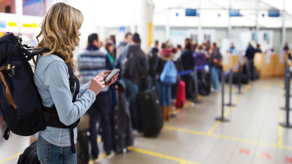 A woman waits in line at an airport in an undated stock photo. 