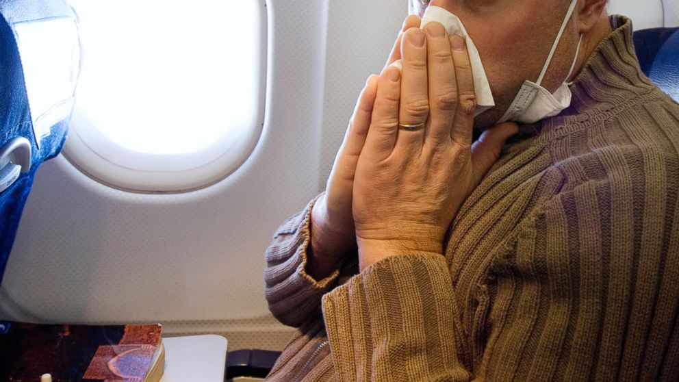 A man with influenza on airplane.