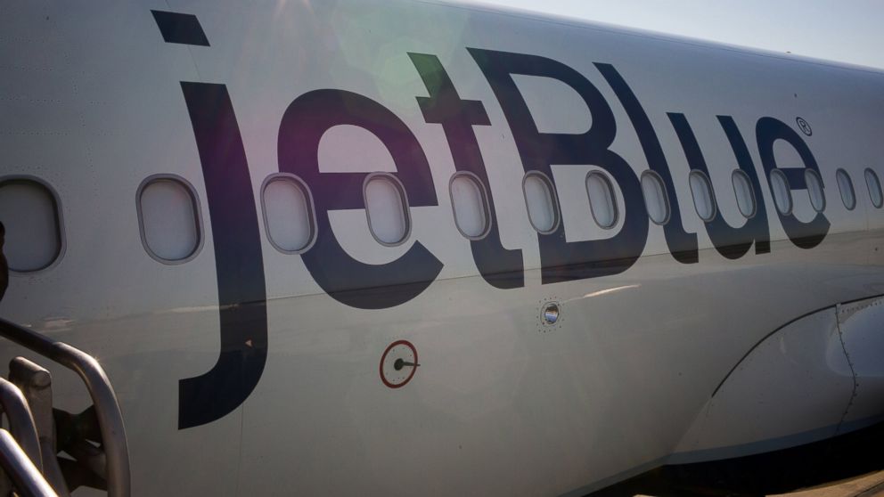 Passengers board a JetBlue Airways plane in Long Beach, Calif., Jan. 5, 2015. 