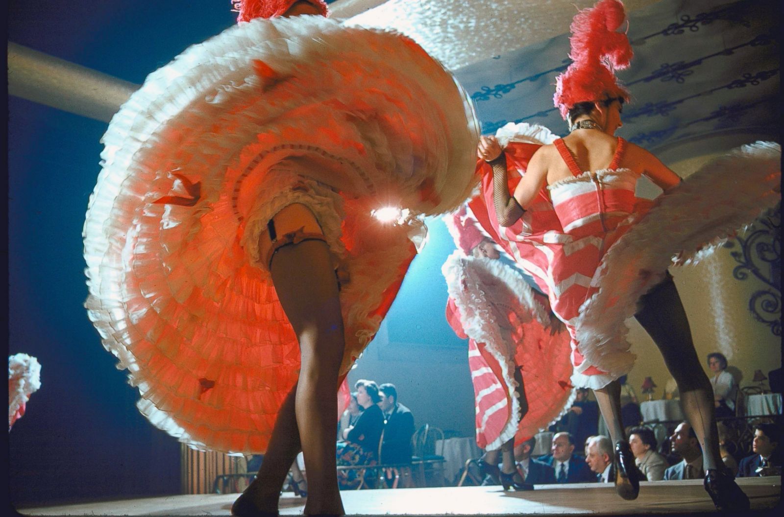 View French Cancan dancers, flipping their skirts to show garters & bla...