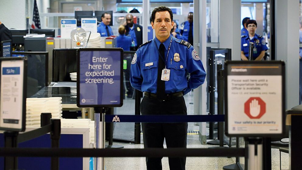 A TSA agent waits for passengers to use the TSA PreCheck lane being implemented by the Transportation Security Administration at Miami International Airport , Oct. 4, 2011, in Miami, Fla. 