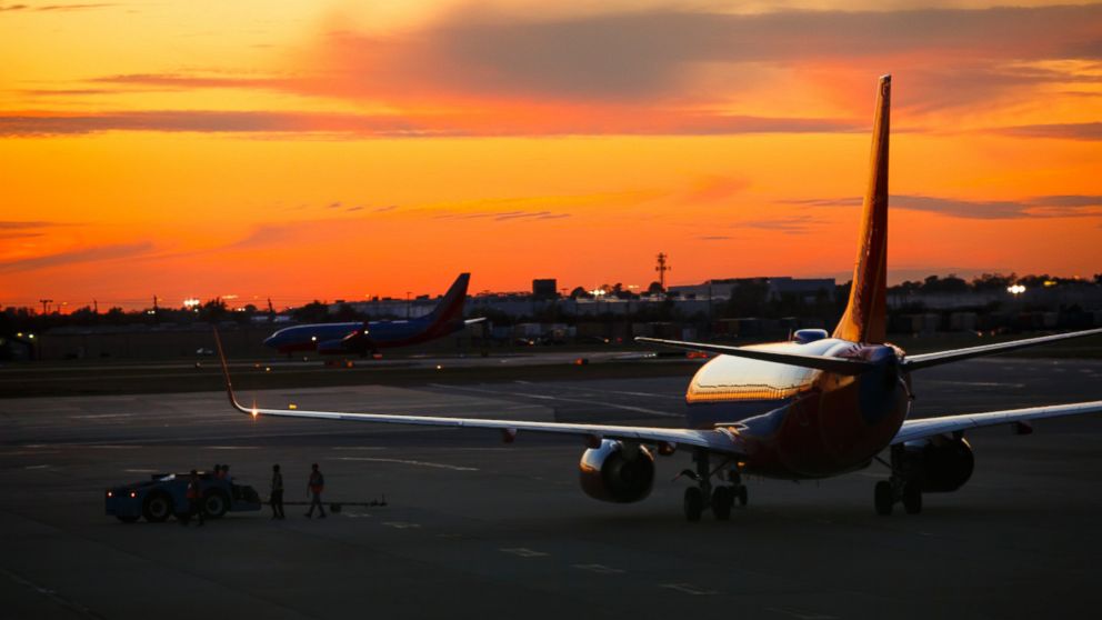 Southwest Airlines Boeing 737 planes prepare for takeoff at William P. Hobby international airport in Houston, Texas, at sunset, November 23, 2015. 