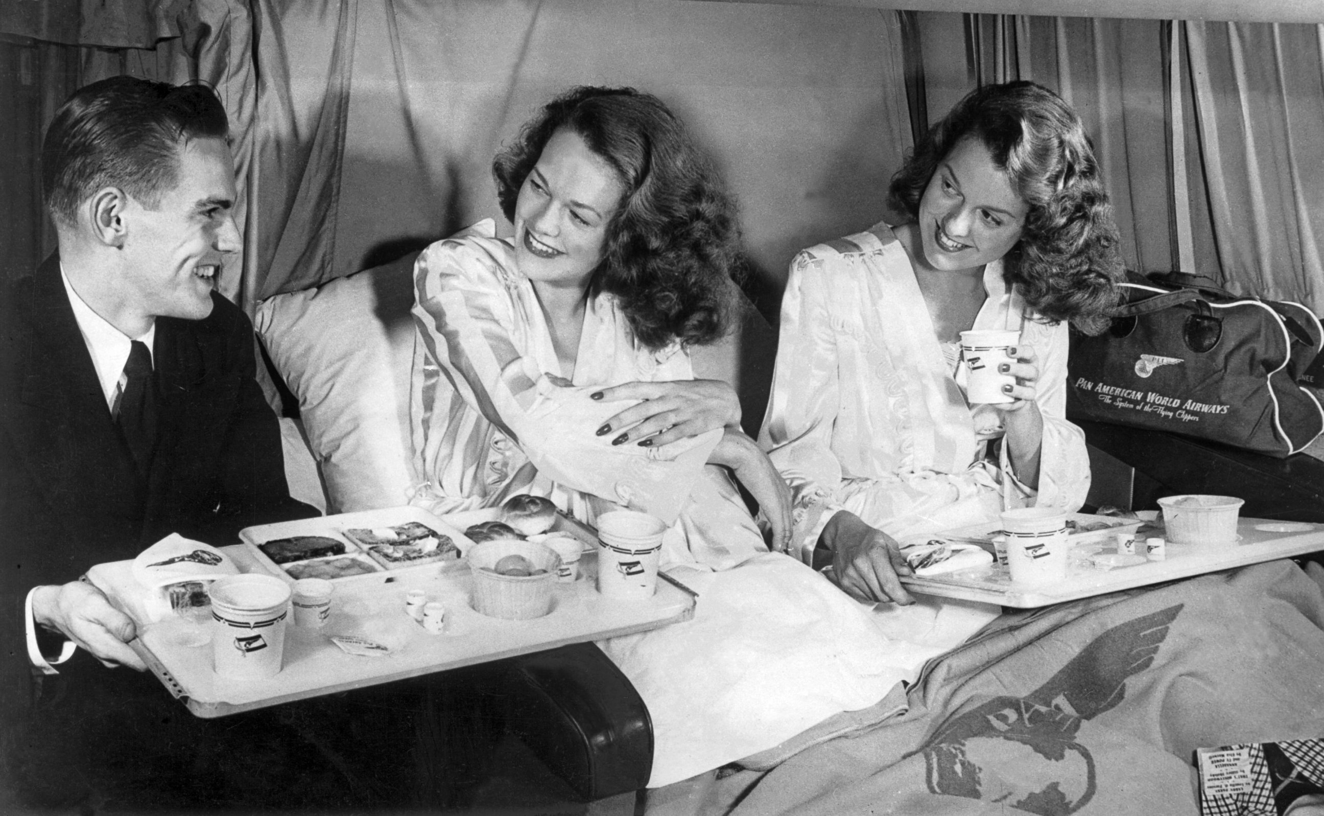 PHOTO: Twin sisters having breakfast aboard a Clipper of Pan American Airways flight during the crossing of the Atlantic, after the U.S. carrier inaugurated the line between New York and London, May 1952.