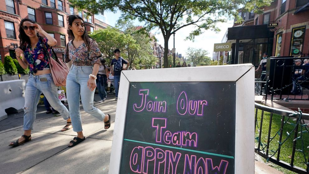 Pedestrians walk past a sign inviting people to apply for employment at a shop in Boston's fashionable Newbury Street neighborhood, Monday, July 5, 2021. As the U.S. economy bounds back with unexpected speed from the pandemic recession and customer d