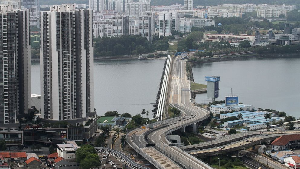 FILE - In this March 18, 2020, file photo, the Johor – Singapore Causeway lies empty in Johor Bahru, Malaysia. Malaysia and Singapore said Wednesday, Nov. 24, 2021, they will partially reopen their borders next week for fully vaccinated citizens and 